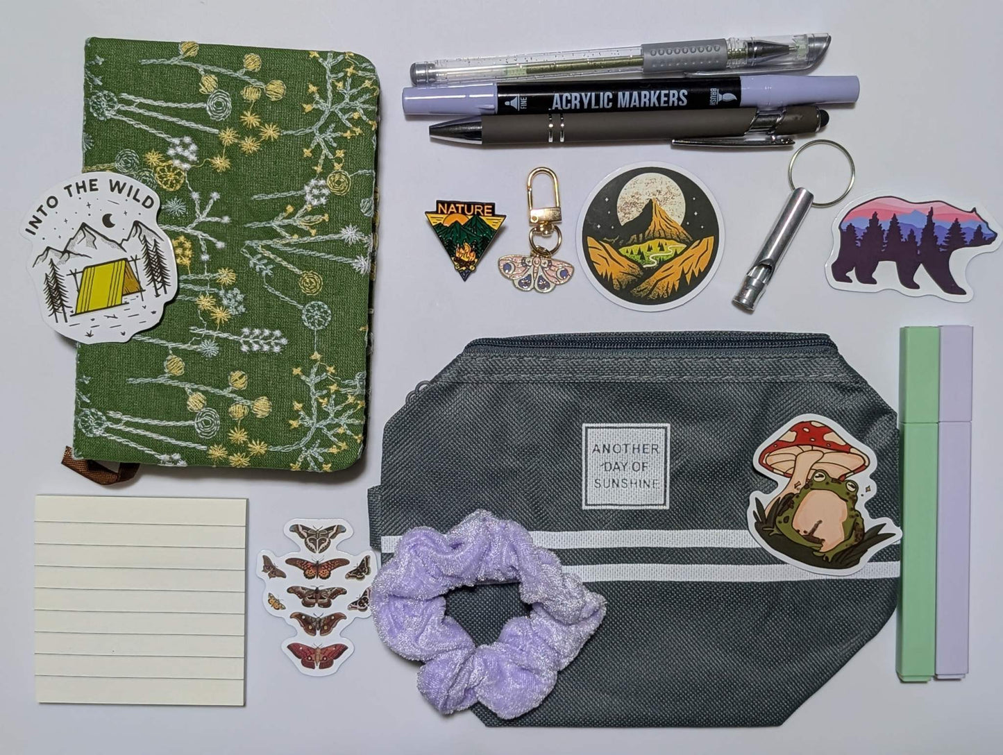 Nature Nerd Basic Bundle with green floral journal, stickers, ballpoint pen, highlighters, gel pen, markers, keychain, sticky notepad, pin, scrunchie, zippered pouch, and whistle keychain