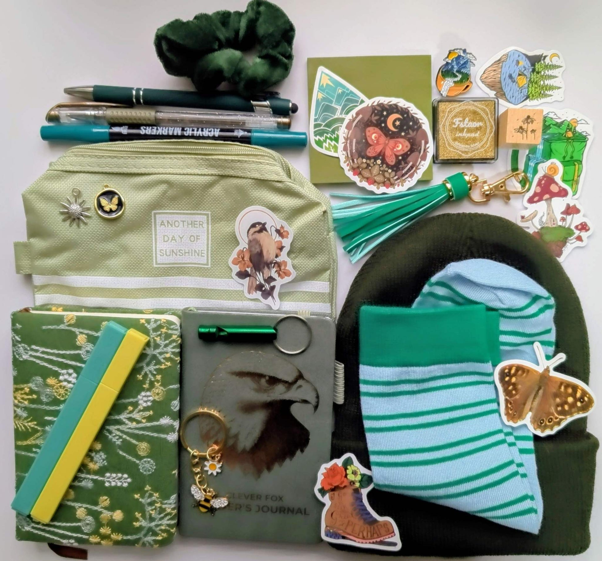 Nature Nerd Legendary Bundle with green floral journal, stickers, ballpoint pen, highlighters, gel pen, markers, keychain, sticky notepad, pin, scrunchie, zippered pouch, and whistle keychain, socks, ink pad, stamp, beanie, charms, birding journal, extra keychain
