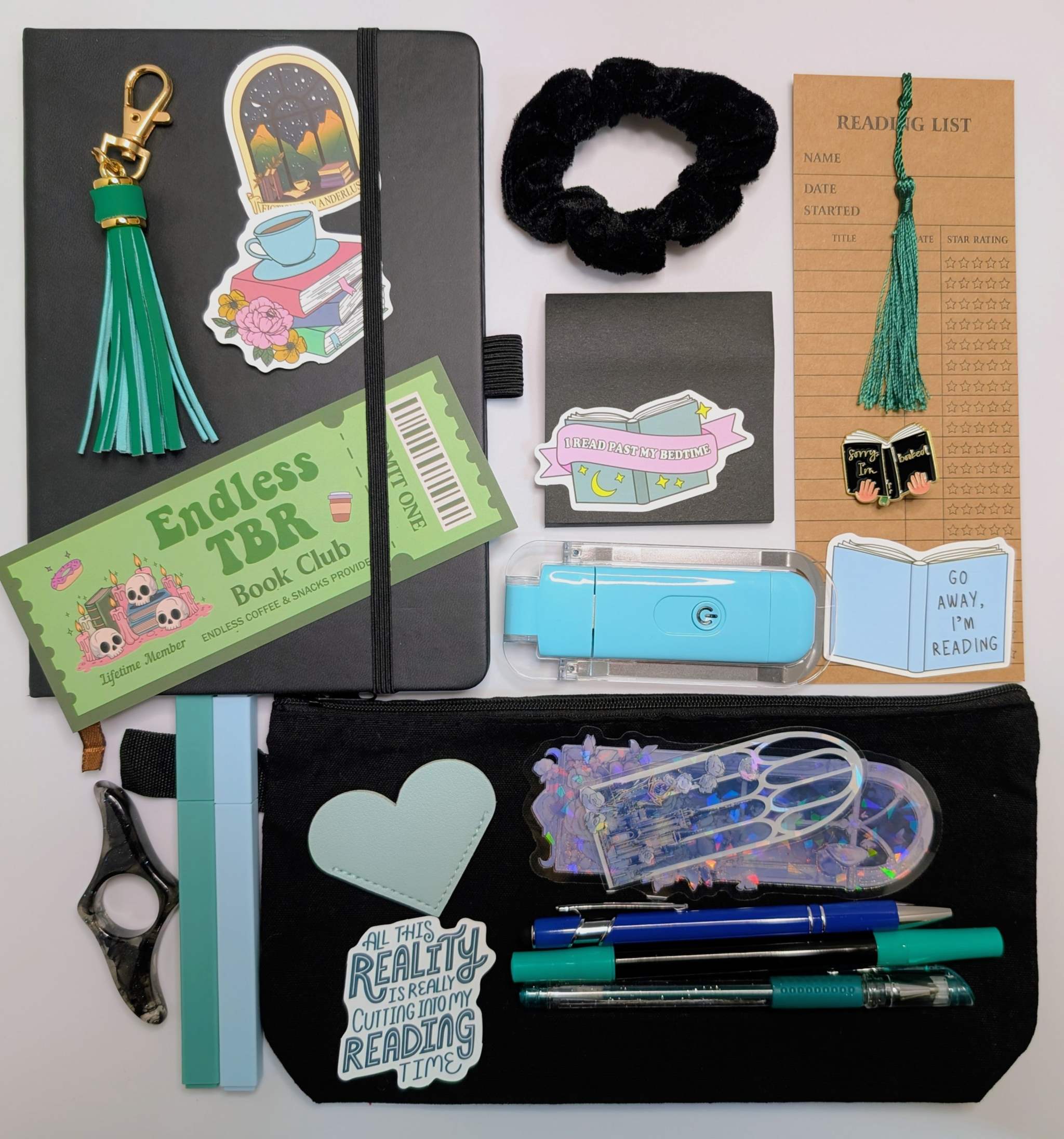 Book Nerd Basic Bundle with journal, booklight, stickers, keychain, bookmarks, highlighters, gel pen, ballpoint pen, marker, acrylic thumb page holder, sticky notepad, zippered pouch, pin, and scrunchie