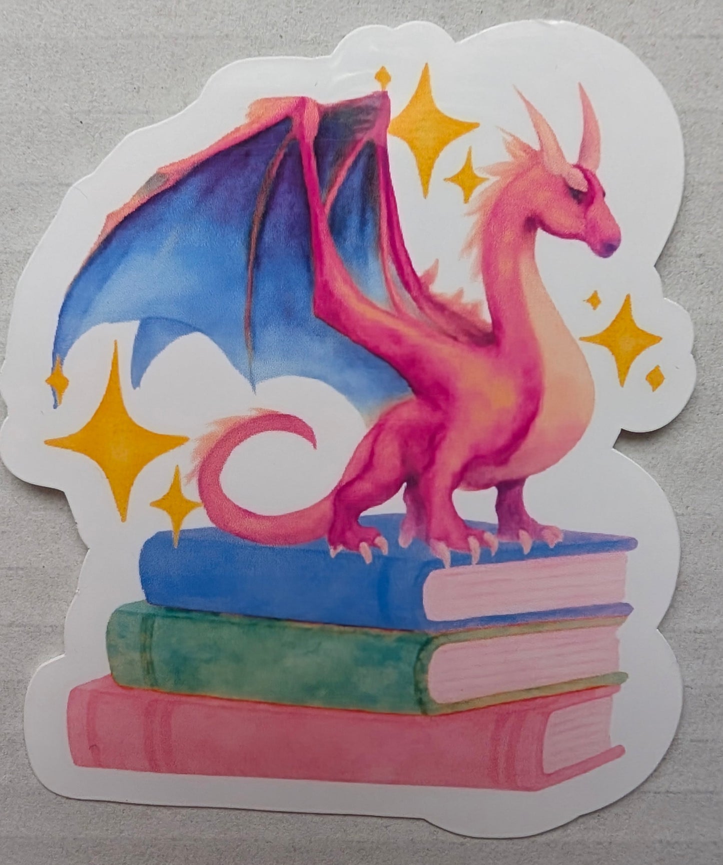 sticker of dragon on a stack of books