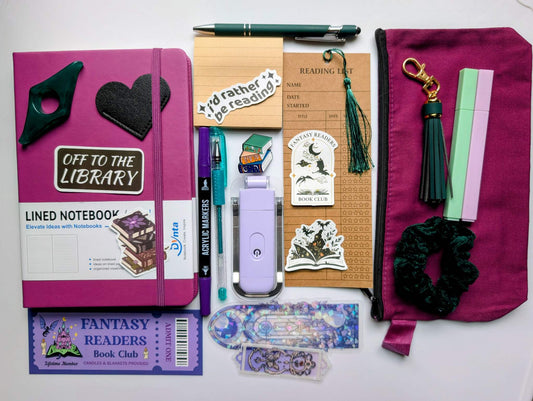 Book Nerd Basic Bundle with journal, booklight, stickers, keychain, bookmarks, highlighters, gel pen, ballpoint pen, marker, acrylic thumb page holder, sticky notepad, zippered pouch, pin, and scrunchie