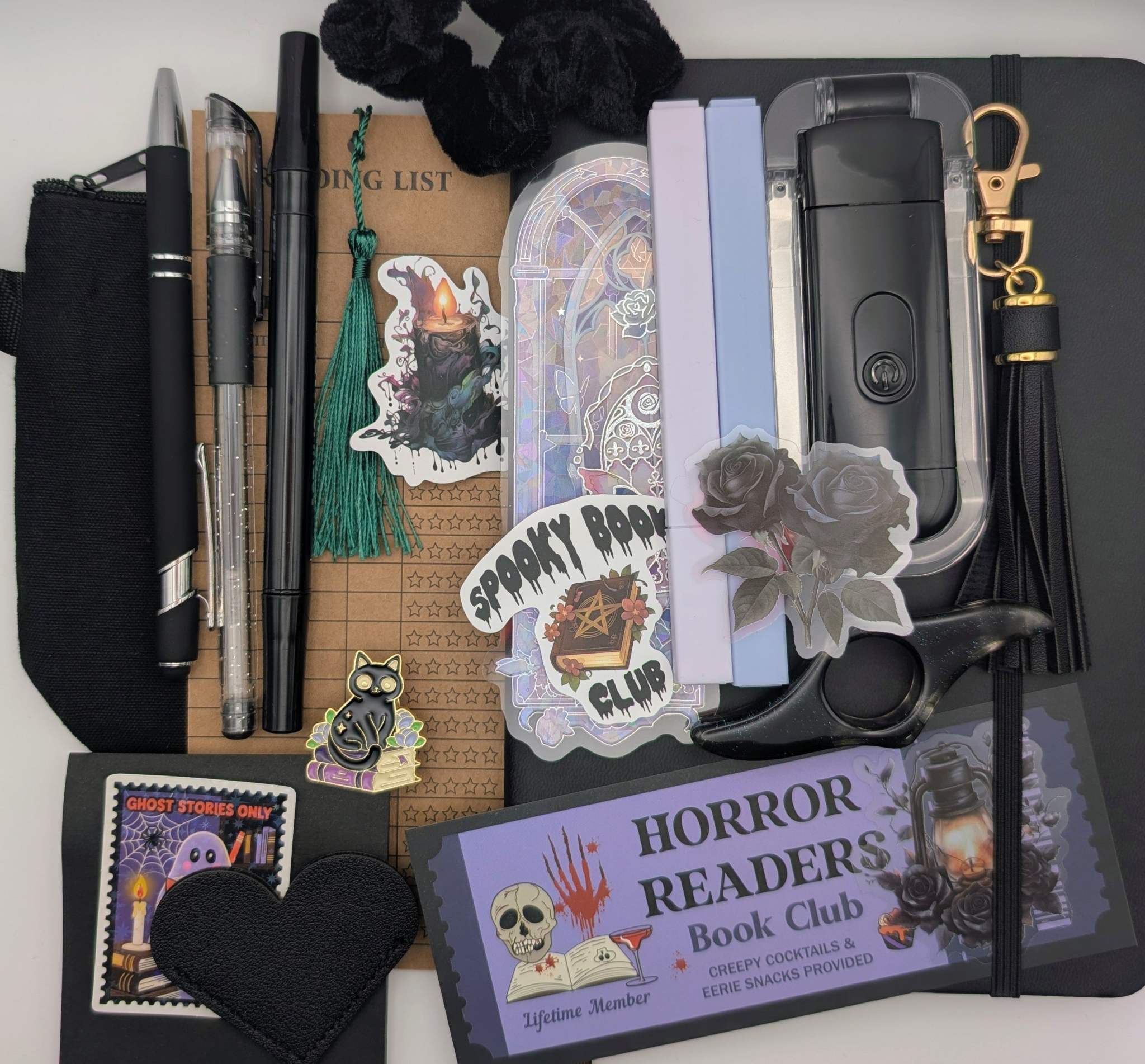 Book Nerd Basic Bundle with journal, booklight, stickers, keychain, bookmarks, highlighters, gel pen, ballpoint pen, marker, acrylic thumb page holder, sticky notepad, zippered pouch, pin, and scrunchie