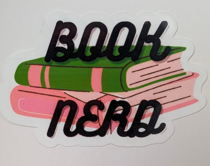 Sticker with a green and pink book and text that says book nerd