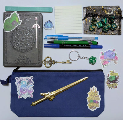 DnD nerd basic bundle with a vintage style notebook, ballpoint pen, gel pen, highlighter, marker, sticky notepad, D20 keychain, sword pen, zippered pouch, pin, stickers, key, sword bookmark, and dice set