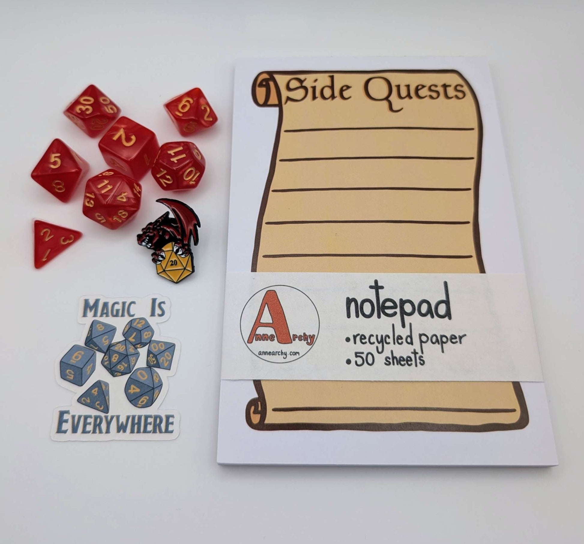 Seven piece dice set, dice sticker, dnd pin, and a notepad that says side quests