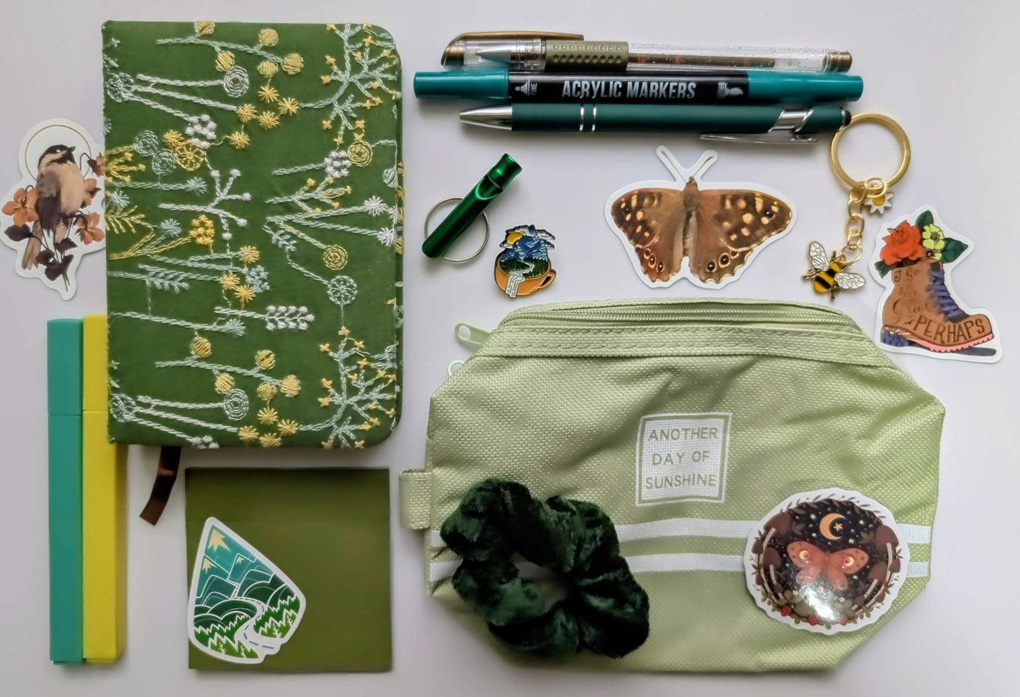 Nature Nerd Basic Bundle with green floral journal, stickers, ballpoint pen, highlighters, gel pen, markers, keychain, sticky notepad, pin, scrunchie, zippered pouch, and whistle keychain