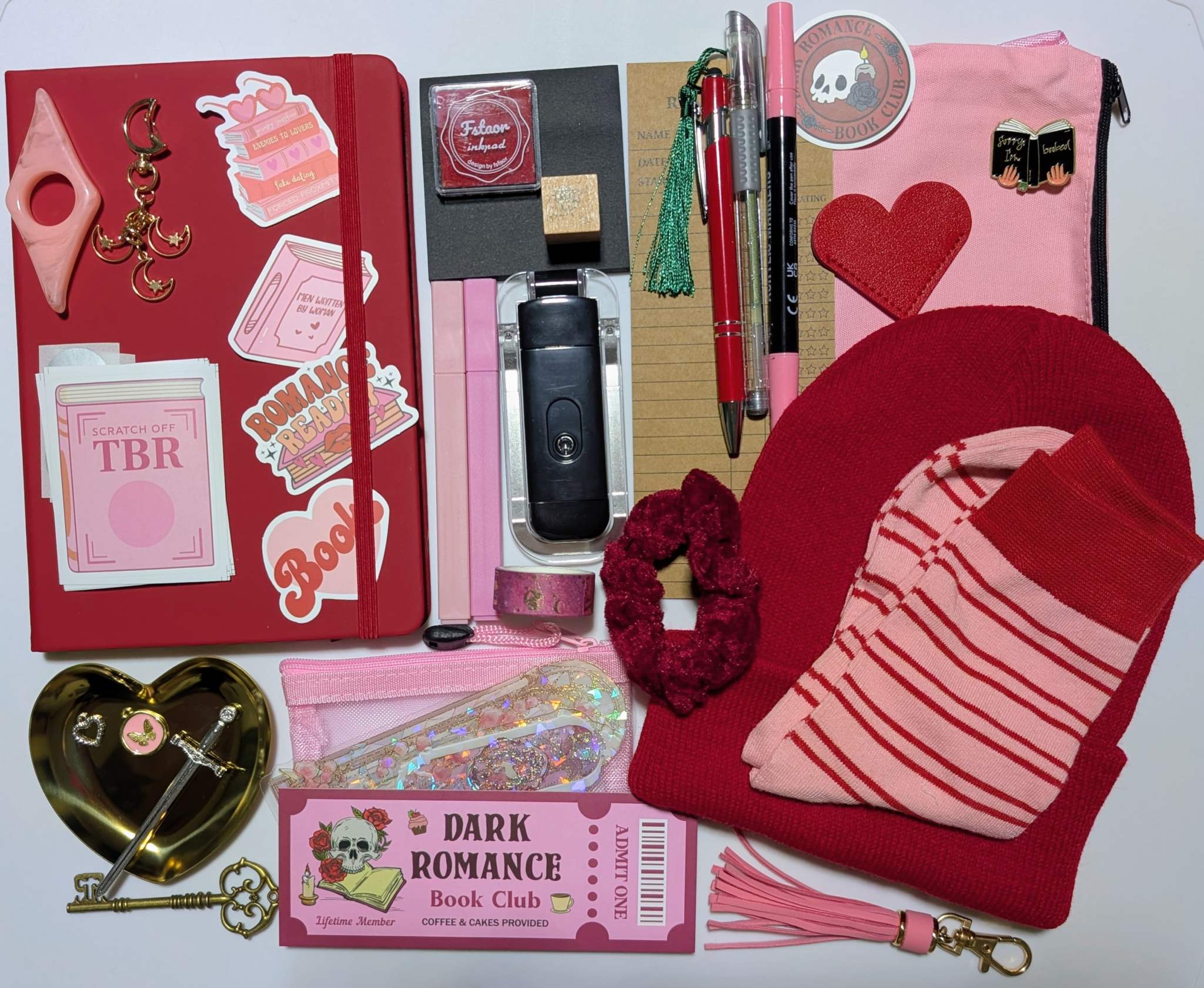 Book nerd legendary bundle with journal, book light, socks, stamp, ink pad, TBR scratchers, stickers, keychain, bookmarks, zippered pouch, highlighters, gel pen, ballpoint pen, marker, page holder, sticky notepad, pin, scrunchie, beanie, trinket dish, keychain, metal feather bookmark, washi tape, key, charms, sword bookmark, mesh pouch