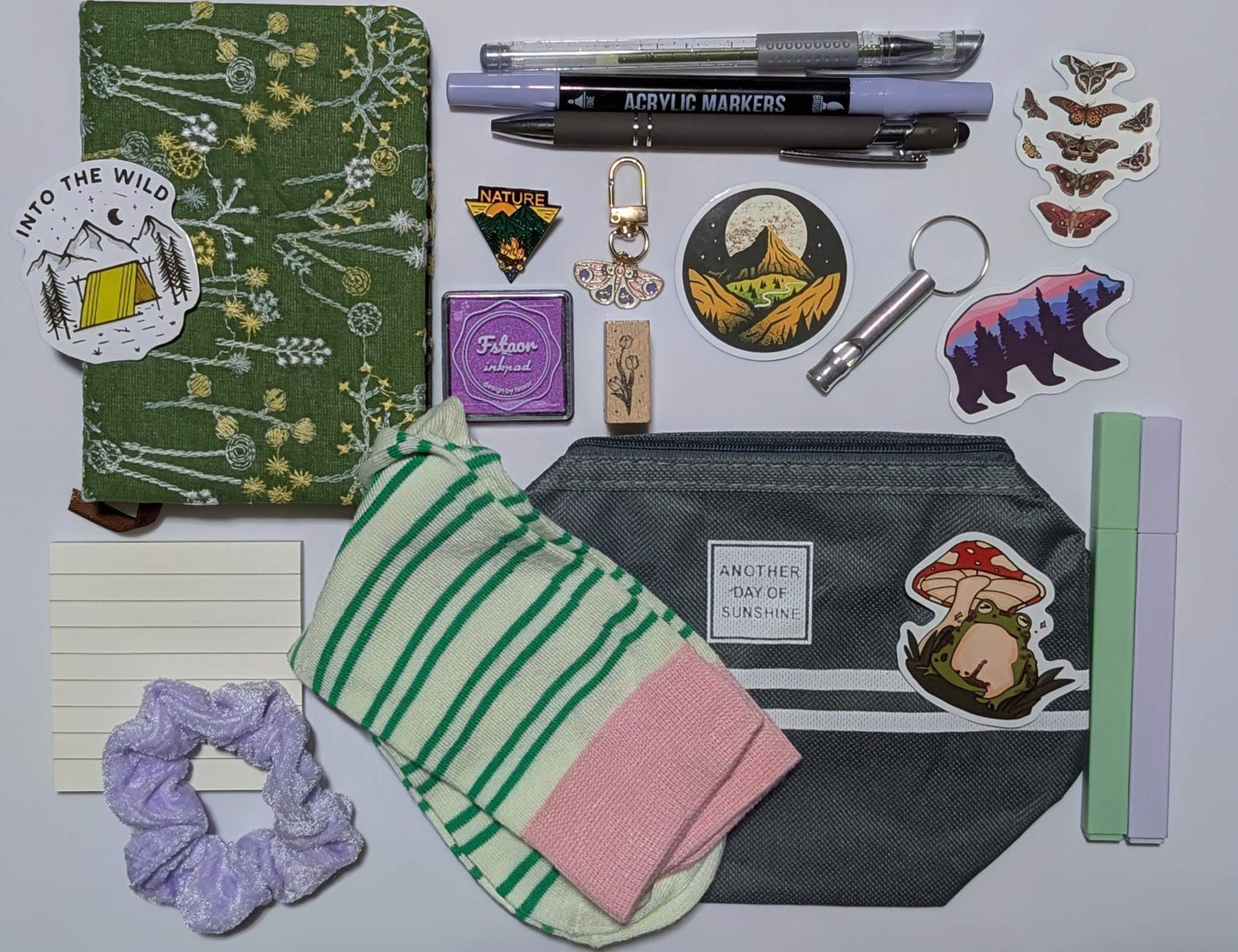 Nature Nerd Deluxe Bundle with green floral journal, stickers, ballpoint pen, highlighters, gel pen, markers, keychain, sticky notepad, pin, scrunchie, zippered pouch, and whistle keychain, socks, ink pad, stamp