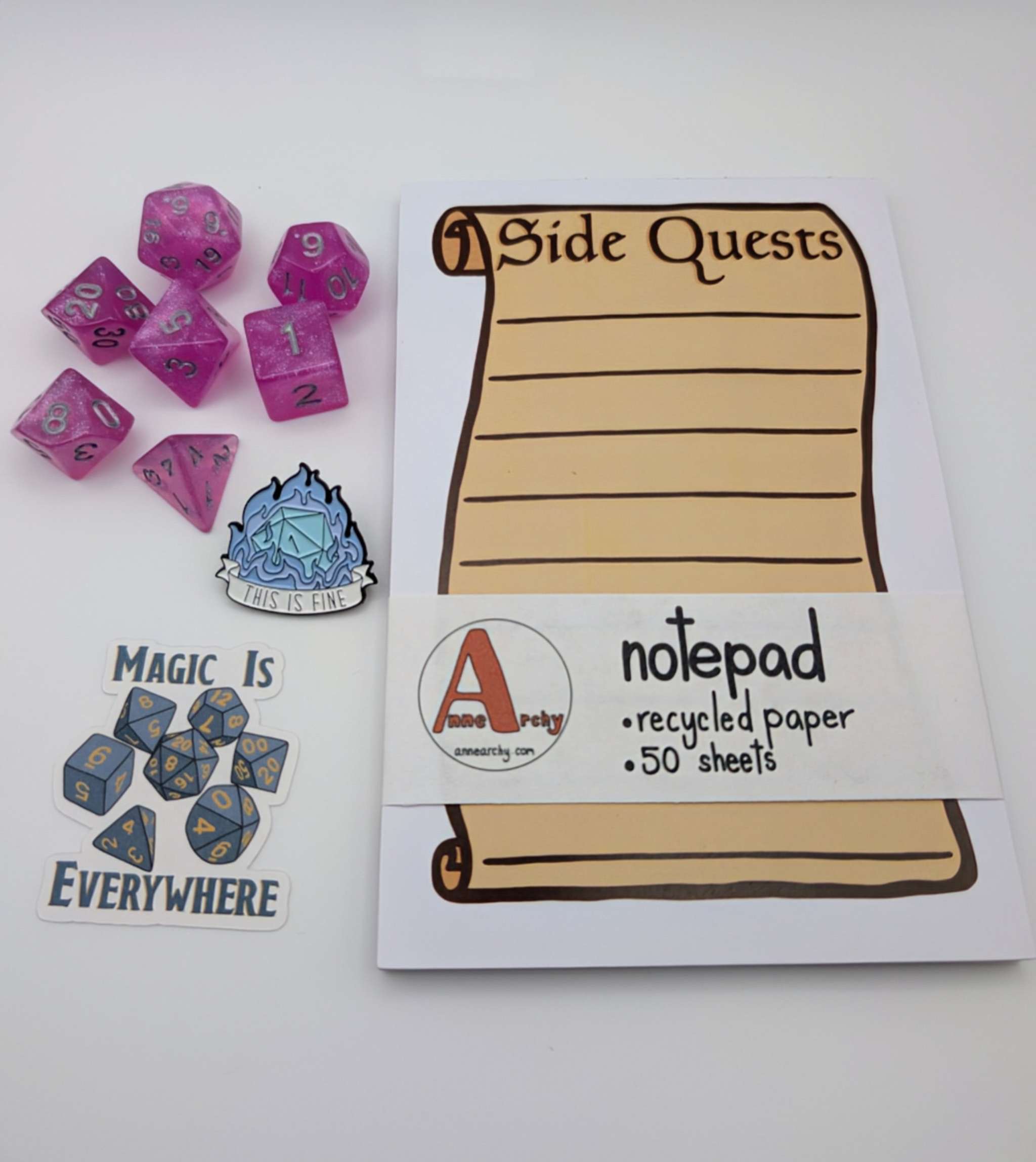 Seven piece dice set, dice sticker, dnd pin, and a notepad that says side quests