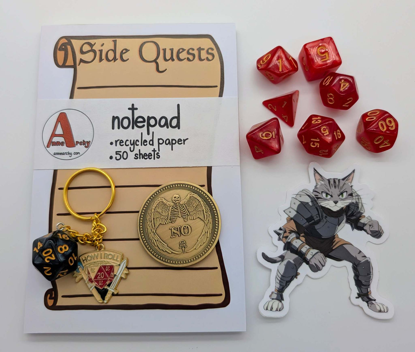 A side quest notepad, DnD inspired keychain, dnd class cat sticker, yes/no decision coin, and a dice set